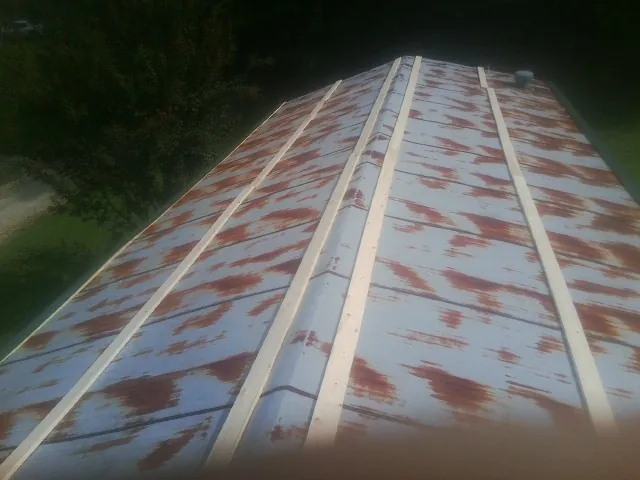 Rusted metal roof panels with new wood purlins before replacement — Storm Damage Roof Repair in Southampton by Roofing Brothers
