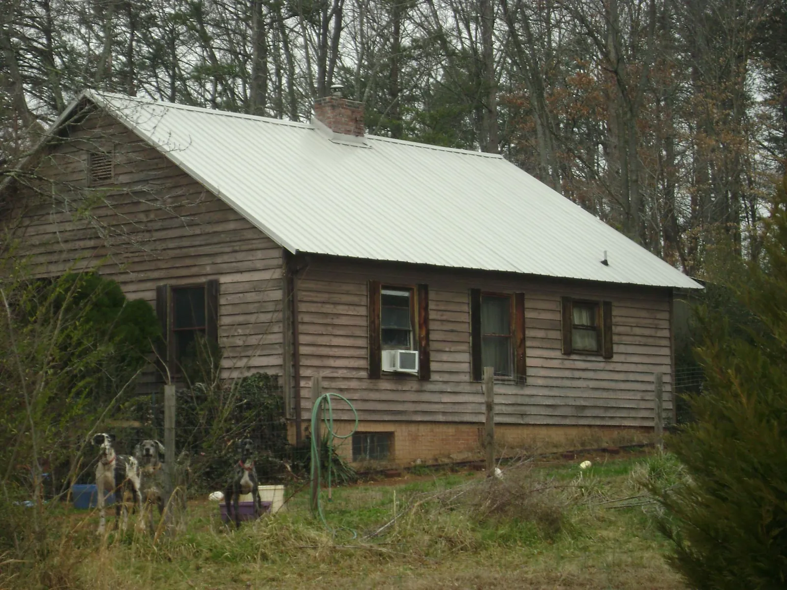 White metal roof on an old wood sided farmhouse, from a Metal Roof Installation job in Southampton
